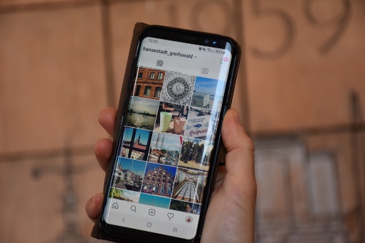 Handybildschirm, geöffnet ist die App Instagram, Bilder aus Greifswald 