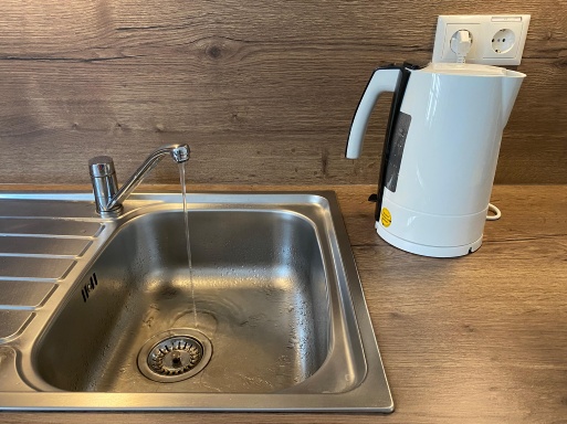 tropfender Wasserhahn und Wasserkocher in einer Küche