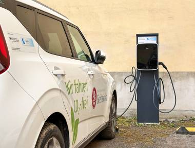 Elektrofahrzeug neben einer Ladesäule